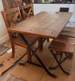Table with 4 stools and 2 chairs. Made of wood and metal.