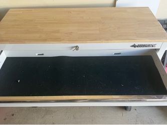 Husky toolbox with a wood top and power outlet