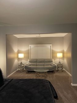Gray Leather Sofa with Glass Coffee Table and Lamps