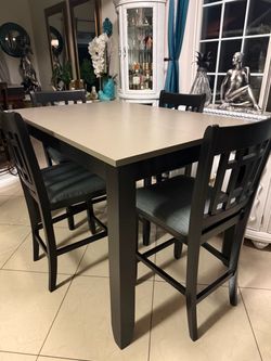 High Dining table 54” long 36”wide and 37” high with 4 very sturdy clean and chairs  in good condition (table comes with an extension)