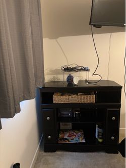 Black entertainment center with storage cabinets