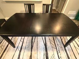 Dark wood dining table with leaf and 6 chairs
