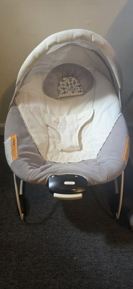 Graco rocking chair, Simmons crib, and Ergobaby baby carrier, all in good condition.