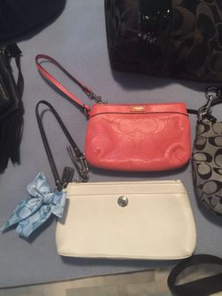 Salmon colored coach wristlet