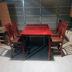 counter height cherry table with 4 black padded seat cherry chairs