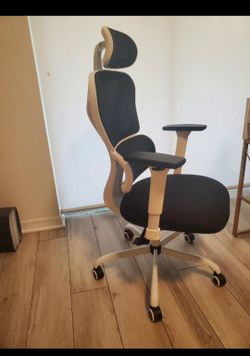 Comfortable ergonomic office chair with adjustable headrest and armrests.