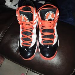 Jordan 6 Rings sneakers in the White, Black, and Team Orange colorway. 
