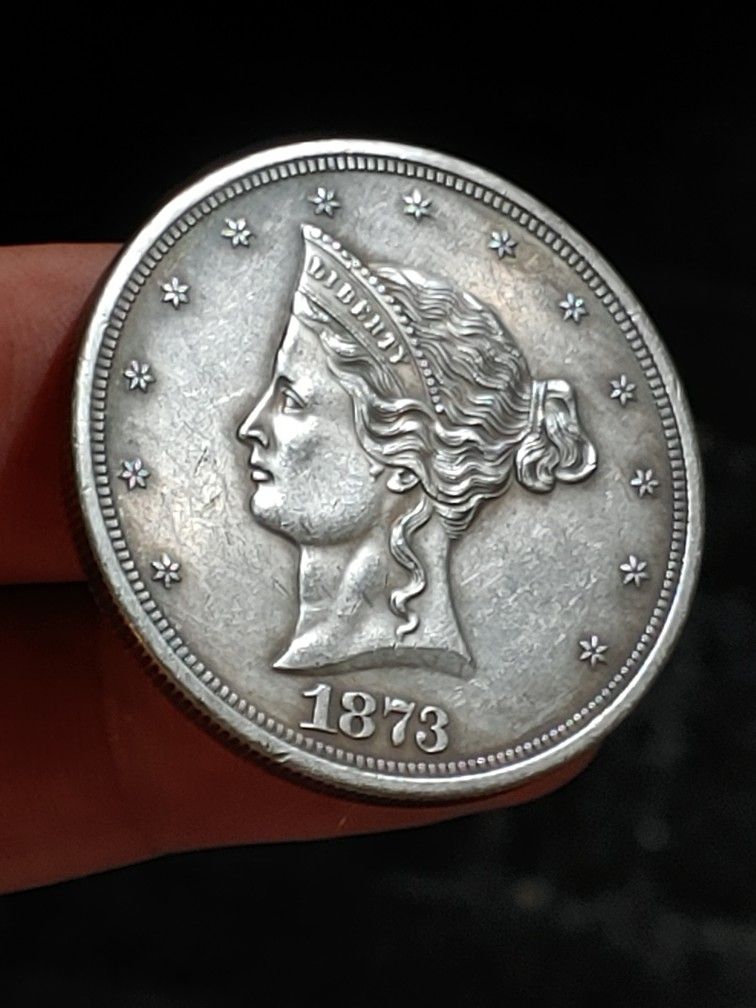 (ART-RECREATED COLLECTING COIN) 1873 TRADE DOLLAR.** LIBERTY $1 ** D: 38.0X2.4MM. W: 21.4GR.**METAL:  BRASS/SILVER PLATED.