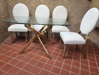 Dining table set with 4 upholstered chairs .