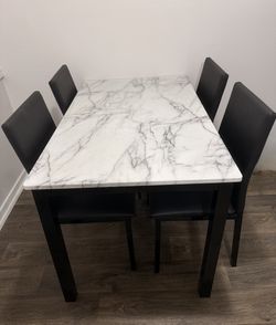 Selling 5-piece dining table set including the table and 4 chairs in excellent, like-new condition