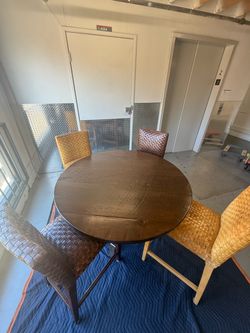 Dark Round Wood Dining Table with 4 Woven Chairs