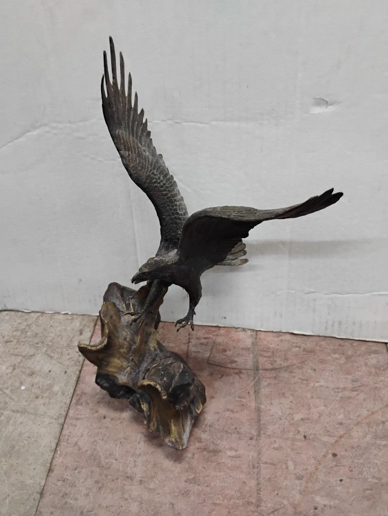 Bronze sculpture of an eagle in flight, titled "Wings of Glory" by British artist Ronald Van Ruyckevelt .