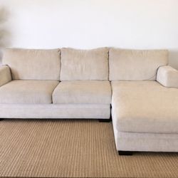 Living spaces - Sectional sofa with a left-hand chaise in a light beige color. Can deliver with deposit.