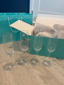 Perfect for showers and weddings and the holidays!  Tiffany and Company, champagne flutes- four glasses .. We’re selling FOUR for $150.  Comes with or