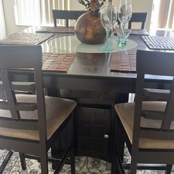 Dining room table set with six chairs table has glass in the center  base of table  has storage