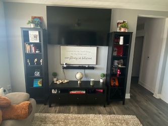 Entertainment center/ Ashley furniture, two large towers to left and right & center with plenty of storage