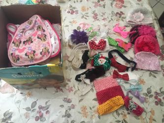 Box of baby clothes and bows