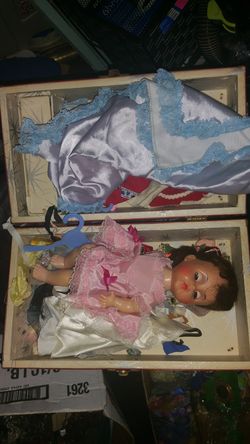 Old doll with lots of doll clothes in old doll box