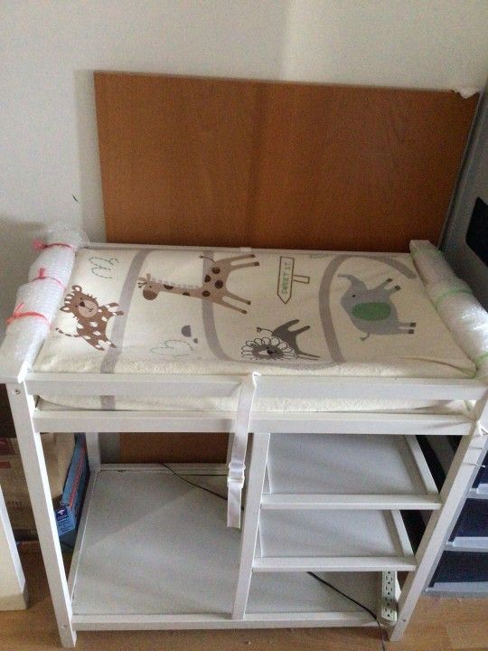 white changing table + changing pad + two pad covers