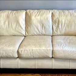 Leather Sofa-Ashley Furniture-Cream Color. 3 Seat with Cherry Color Wood Trim- Used in good condition.   