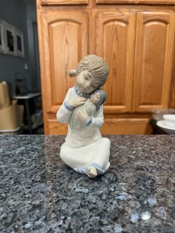 Vintage Retired Zaphir Lladro “Girl and Doll Baby” figurine.  Side approximately 6 inches tall.  Preowned excellent condition.  There are no white spo