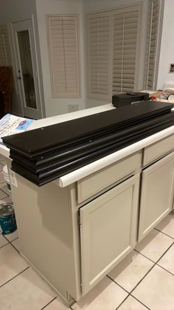 Set of three dark colored shelves