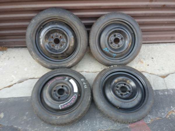 Four steel spare rims with tires 4x100mm lug pattern. Good rollers