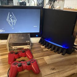 PS3 with 2 controllers an 5 games