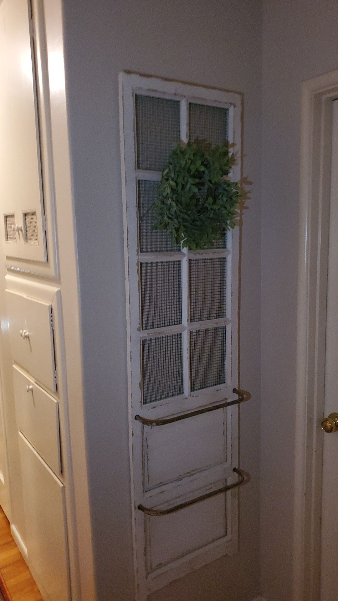 Selling Ashley's furniture door decoration with greenery.