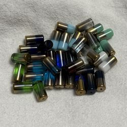 34 PIECES. GLASS PILLAR “BEAD SOUP” IN A VARIETY OF FLAVORS  approx 1” x 1/2”