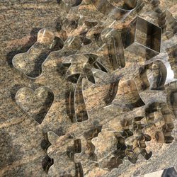 32 Cookie Cutters. Good condition. Tin box included 