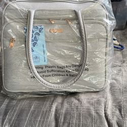 LUGGAGE,   Very Sophisticated Piece With Wheels, Sparking Silver, BEAUTIFUL GIFT. JENNY CHAN BRAND, 17”x15”. BRAND NEW  STILL IN PLASTIC. HAS 4 COMPAR