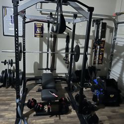 Squat Rack Plus A Lot Of Weights And Extras