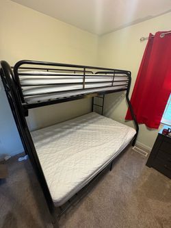 Metal black twin up top full down bottom bunk beds. Night stand and dresser with mirror also at