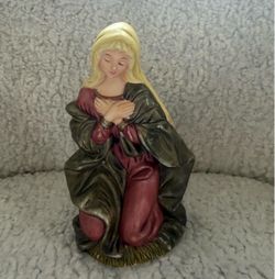 Mary statue with gold and red robes, kneeling with hands clasped. #religious #christian