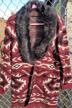 Red, black, and cream colored sweater size large can fit med as well