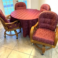 Beautiful glass top table w/4 rolling wicker chairs