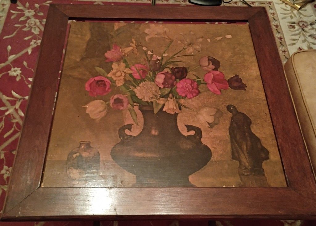 A charming 1940s vintage tilt-top table featuring a vibrant floral still life at its center.