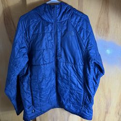 The North Face Men's Circaloft 1/4 Zip Pullover in blue. The jacket is made from 100% recycled polyester with synthetic insulation and a durable water