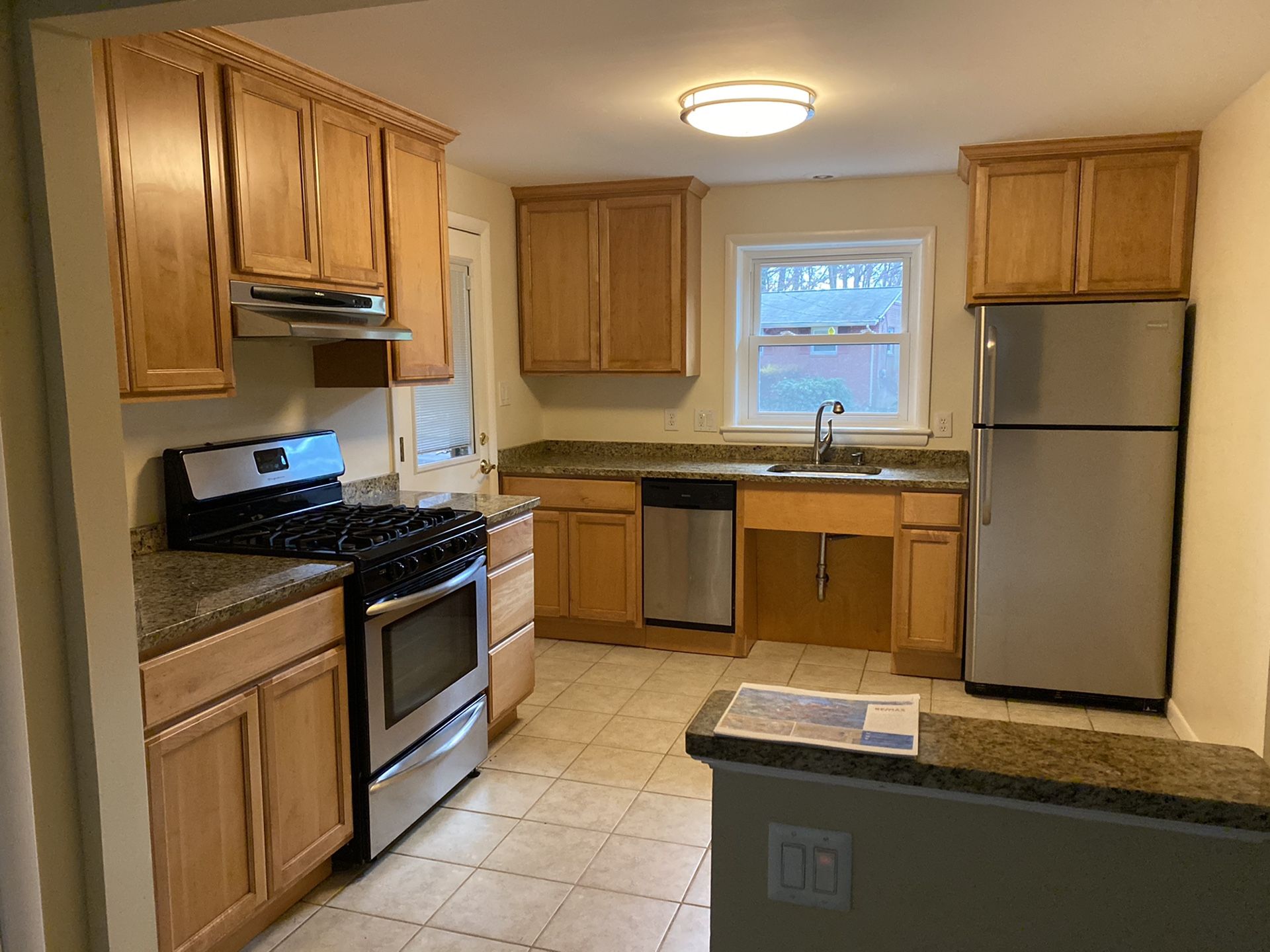 Entire Kitchen - Refrigerator, gas stove, dishwasher, cabinets, and granite countertops