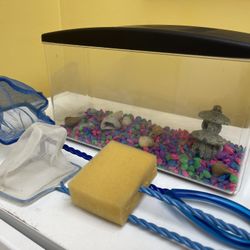 Small Fish Tank With Pebbles And Cleaning Sponge And Nets