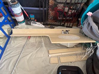 Used bathroom countertop with sink and faucet