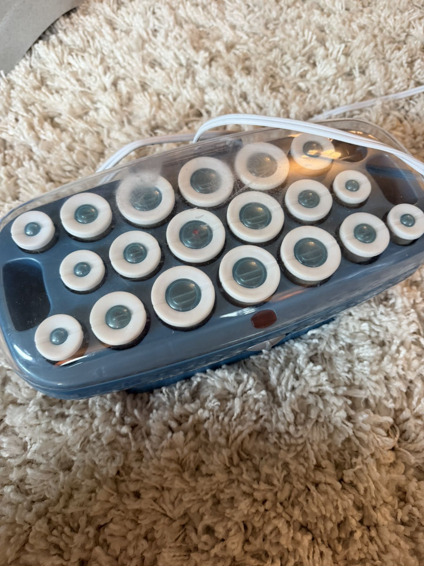 Stylish hair roller set in blue and white. Perfect for creating stunning curls. Missing one.