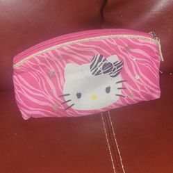 Hello Kitty Pink Zebra Utility Case, also referred to as a pencil pouch or cosmetic bag. This is a Sanrio-licensed product that features a bright pink