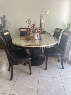 Round marble dining table with chairs
