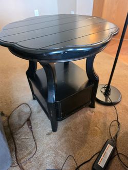 Black scalloped end table with lower shelf and drawer.
24"w