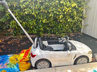 Toddlers play slide and push BMW car $20 each