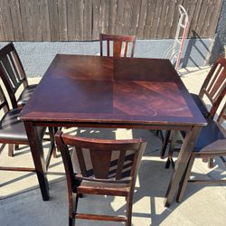 dark wood counter-height dining table and  6  chairs set. Size Table 36” H  And Chair  24” H 