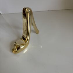 Small ceramic gold color stiletto. New. 3”3/4 by 3”1/4 by 1”. Comes  from a smoke free environment. 