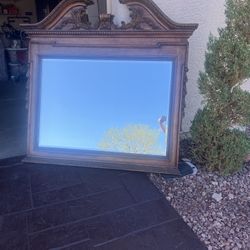 A Beautiful Beveled Mirror/carved on top